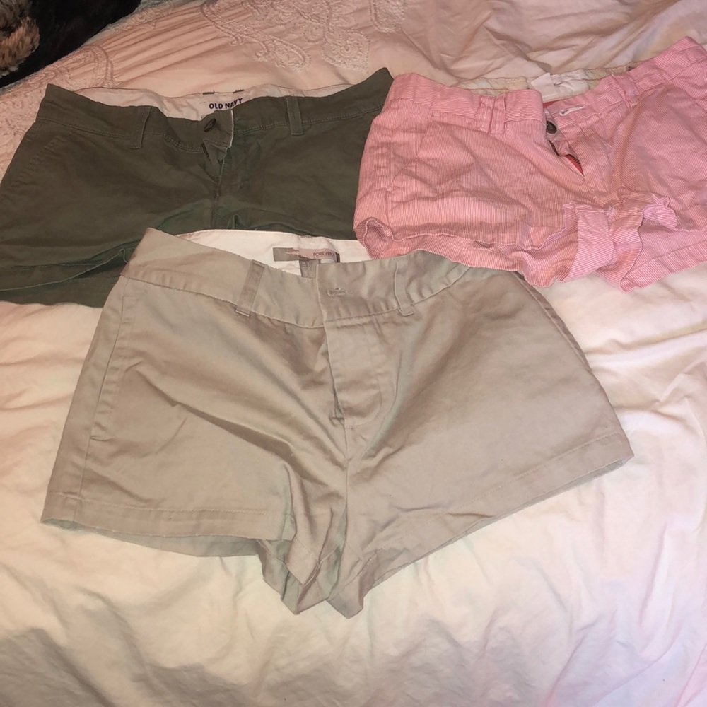 Three colored shorts: white and red, olive, khaki